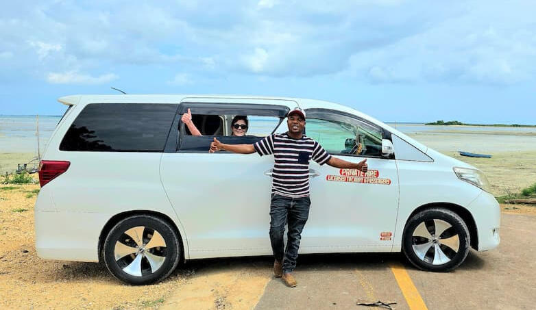 Suley with a guest in his air-conditioned van near Nungwi Beach
